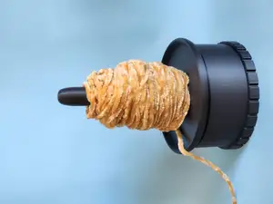Yarn spinner/holder with weight