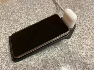 Wireless iPhone charging stand with integrated AirPod dock