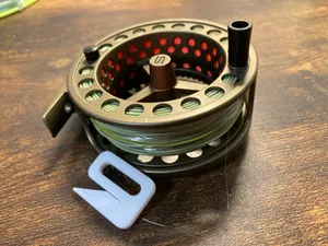 Fishing line stopper for fly reel