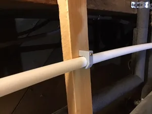 Plastic plumbing pipe hanger (screw-in j-hook pipe support)