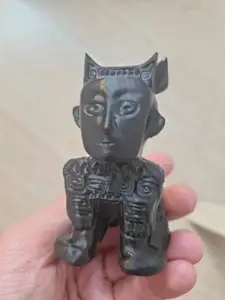 Model of a chinese figurine from a waring states period Copper socket (likely an instrument holder)