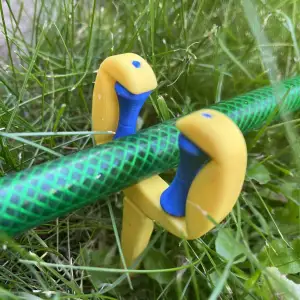Holding, guiding the garden hose