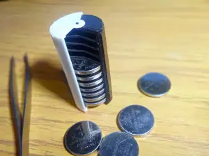 CR 2032 compact battery case with rotating lid