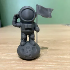 Mini Spaceman on rock with flag