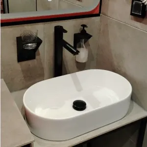 Liquid soap holder and a cup for toothbrushes