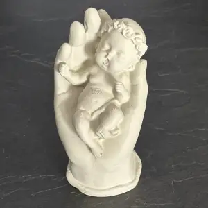 Hand Holding a Baby – A Symbol of Love and Protection