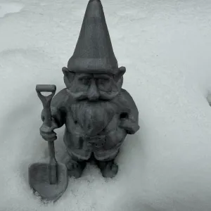 Winter dwarf, gnome, hobbit with snow shovel