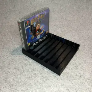 Games stand holder for PlayStation One (PSX, One)