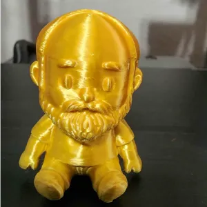 CubeMe but goldish and sitting.