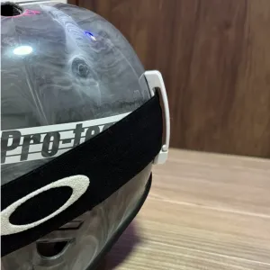 Helmet goggle strap clip