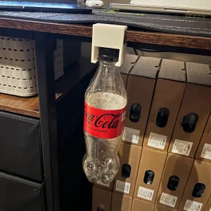 Desk holder for Coca-Cola bottle