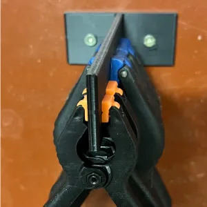 Wall mounted spring clamp holder
