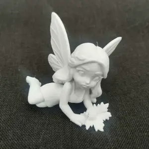 Woodland Fairy Laying on Side Holding Forest Leaves Statue