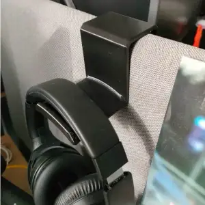 Headphone holder mounted on cubicle divider