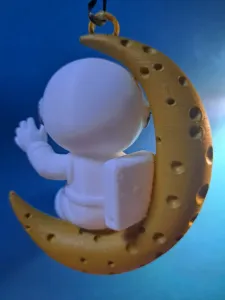 Hanging waving astronaut on Crescent Moon