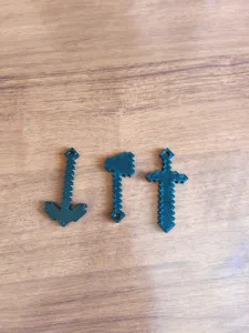 Minecraft keychain with a sword, pickaxe, and axe