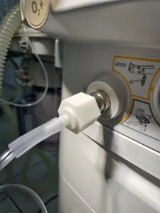 Anesthesia machine adapter for fresh gas outlet